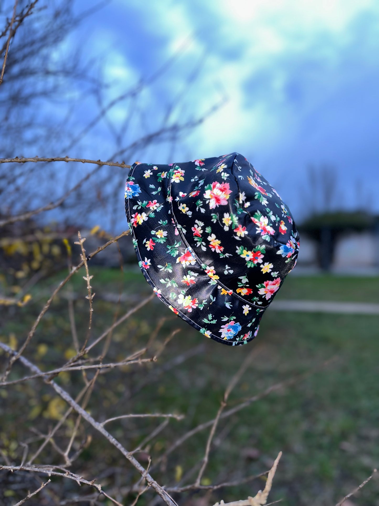 Bob réversible en tissu imperméable rose pâle et noir à fleurs