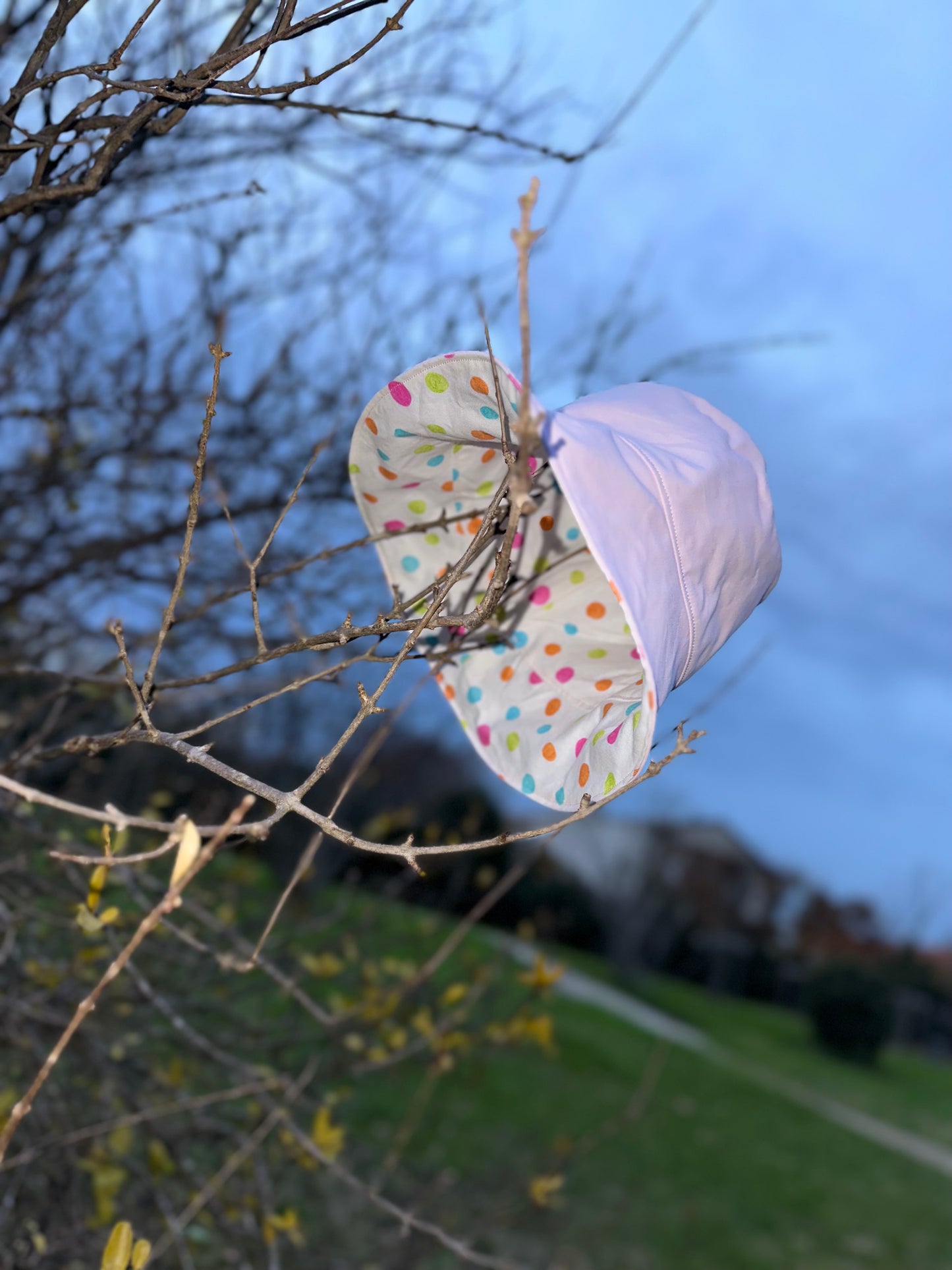 Bob réversible en tissu imperméable rose pâle et coton à pois multicolores